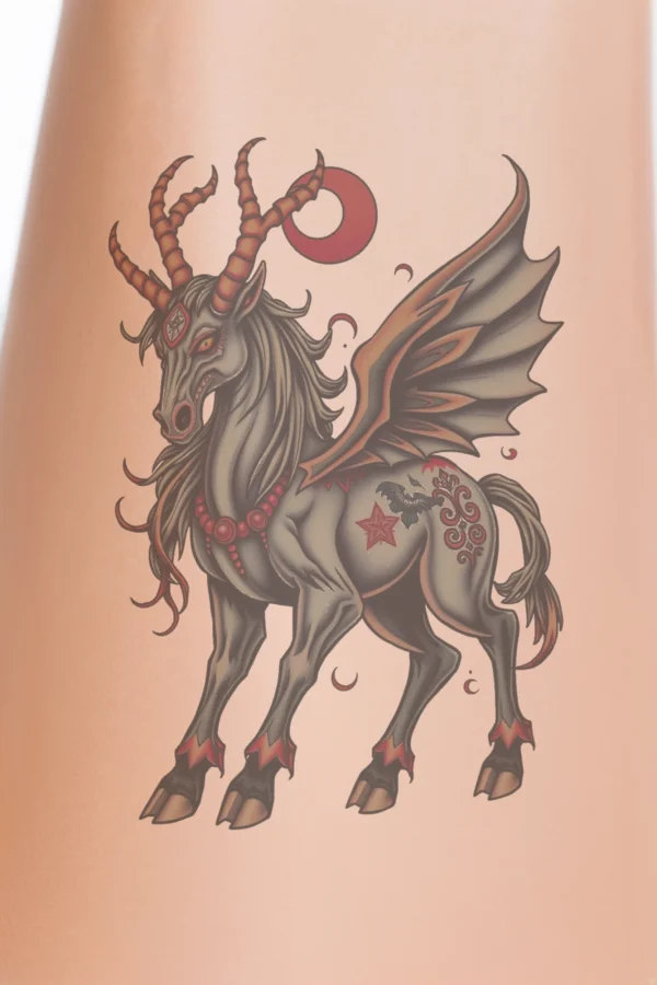 Close-up of a person's lower legs featuring a detailed temporary temporary tattoo on the calf. The temporary tattoo depicts a fantastical creature with a horse-like body, dark mane and tail, and wide-spread orange and red wings adorned with black markings. The creature has
