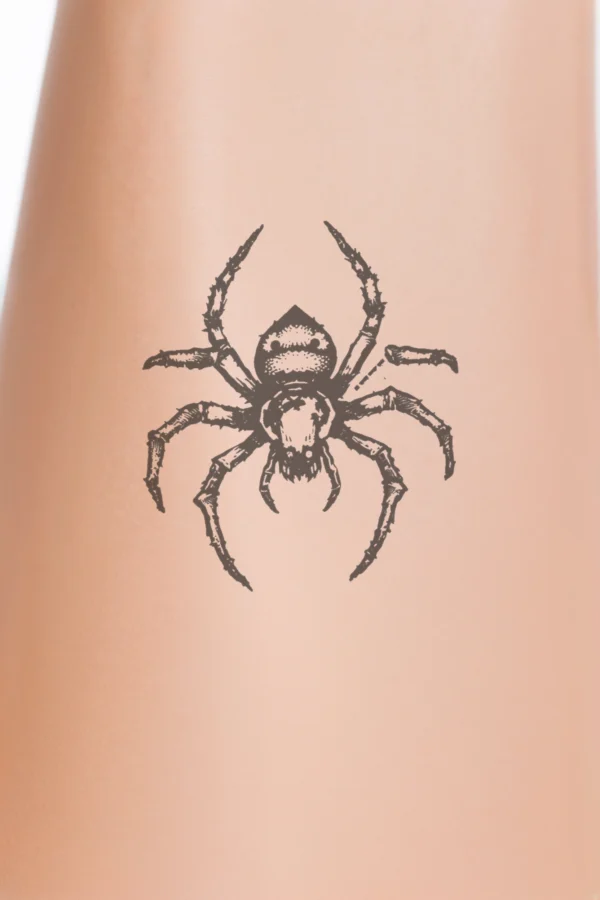 A detailed black and white temporary temporary tattoo design featuring a centrally positioned spider. The spider, facing right, has a predominantly black body with intricate textures on its legs and body. Its legs are spread out with some slightly curled, while its head faces left.
