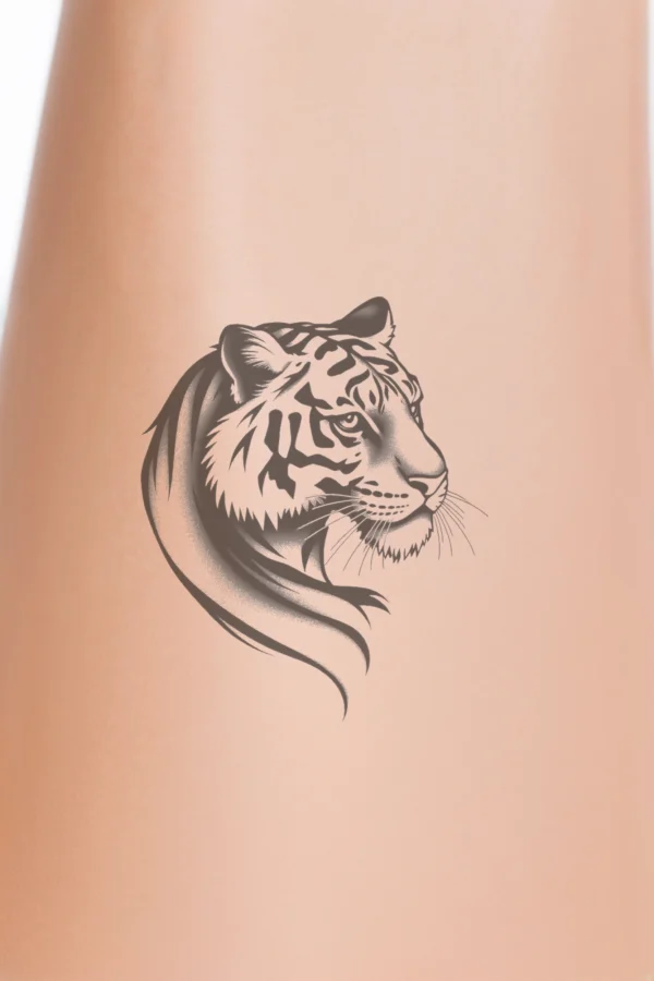 "Temporary temporary tattoo design featuring a striking black and white illustration of a tiger's head and neck, facing right. The tiger's alert eyes and flowing mane exhibit intricate patterns and textures, highlighting its powerful features. Its stylized body is adorned with dynamic stripes