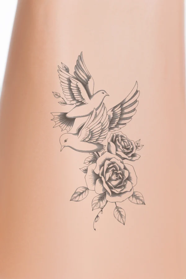 Temporary temporary tattoo design featuring two gray birds in flight, their wings fully extended, soaring above a cluster of delicate pink roses and green leaves on the right side. The birds appear to be in motion, creating a striking contrast against the white background, with the
