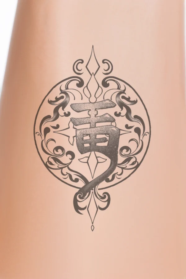 Temporary temporary tattoo featuring a striking black and white design with a central stylized character resembling a flowing "I" or "Y." The character is encircled by an ornate, symmetrical frame inspired by traditional East Asian art, adorned with swirling patterns and decorative
