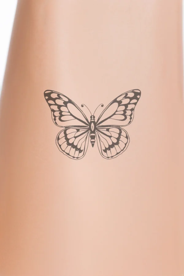 A black and white temporary temporary tattoo design featuring a centrally positioned butterfly facing right. The butterfly has its wings spread wide, showcasing intricate symmetrical patterns. The body, likely black or dark brown, is located at the center, complemented by a small dark head and