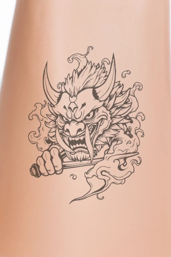 Alternative text: "A black and white temporary temporary tattoo featuring a fierce creature with a large head, pointed snout, and wide-open mouth showcasing sharp teeth. Its intense eyes convey power, and its face is accentuated by a decorative horn or mask.