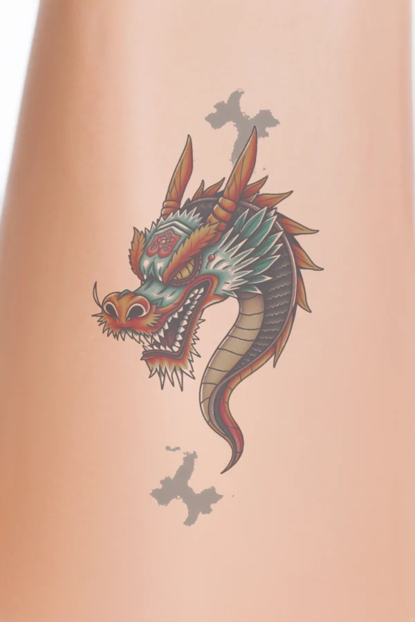 A vibrant temporary temporary tattoo illustration features a dragon's head facing left, with its mouth open in a fierce roar. The dragon's striking yellow eyes contrast against its deep red mouth. Its body showcases a mix of blue and black, highlighted with touches of orange