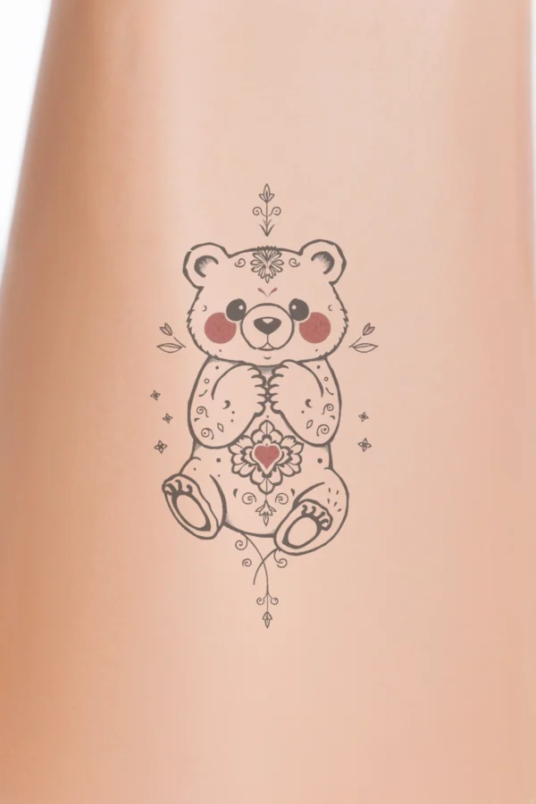 A whimsical black and white temporary temporary tattoo design featuring a stylized polar bear seated with its front paws together. The bear's head tilts slightly to the left, showcasing large round eyes and small rounded ears. Its body is intricately decorated with floral motifs