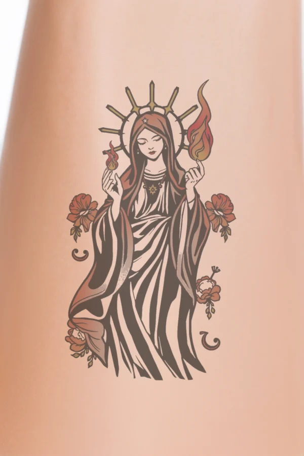 Temporary temporary tattoo design featuring a serene woman, possibly a religious figure, in a long robe and head covering. She holds a glowing flame in her hands and has a radiant halo around her head. A star pendant necklace adorns her neck. The design is