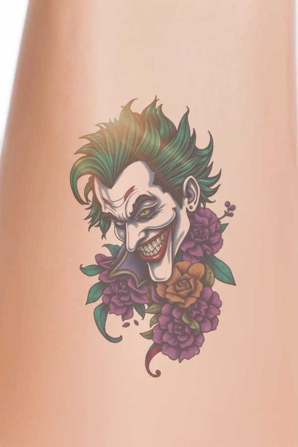 A temporary temporary tattoo design featuring a stylized joker's face, characterized by a vibrant green and black color scheme. The joker displays a wide, toothy grin and a mischievous expression, with striking yellow eyes, a dark red maroon nose,