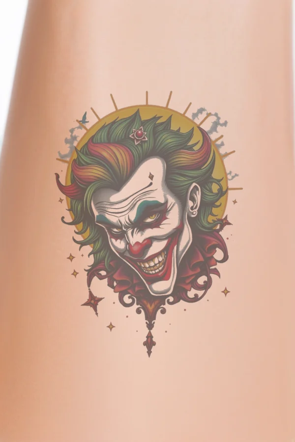 A vibrant temporary temporary tattoo featuring a joker's face in traditional temporary tattoo style, showcasing a red nose, green hair, and a wide, cheeky grin. The intense eyes and mischievous expression add character, while a bold sunburst design frames the face