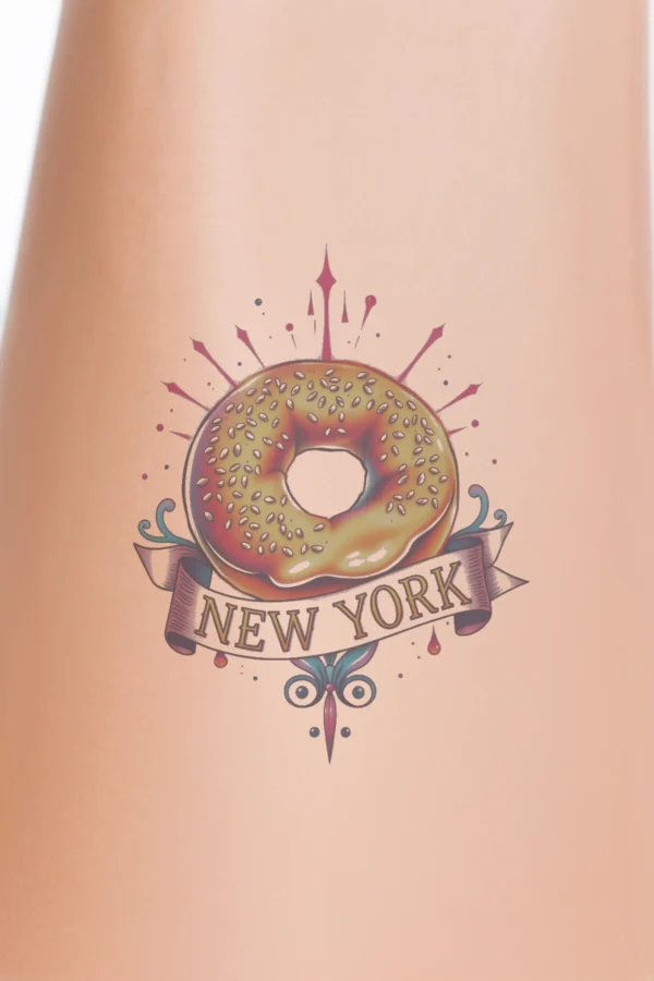 Vibrant temporary temporary tattoo design featuring a centrally positioned donut, topped with sesame seeds and a rich dark drizzle. A light beige banner across the donut reads "NEW YORK" in a stylish font, bordered with red and pink decorations. The stark white background