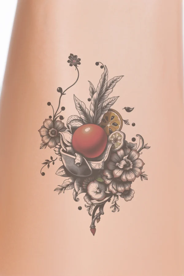 A vibrant temporary temporary tattoo design featuring a still life arrangement with a glossy red apple at the center, surrounded by a lemon, a slice of orange, and a lemon slice. The composition includes a variety of flowers, including a black and white flower, a