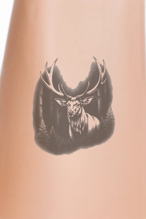 A detailed black and white temporary temporary tattoo design featuring a majestic deer, possibly a stag, with large antlers, set against a dense forest backdrop. The deer’s light brown coat contrasts with the forest's intricate tree details. Its alert gaze is directed at