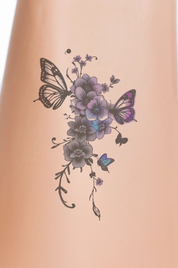 Temporary temporary tattoo design featuring a vibrant floral arrangement with purple, pink, and white flowers, along with small dark-colored blooms. The flowers are loosely cascading, with some upright. Set against a white background, the colors stand out boldly. Blue and purple butterflies