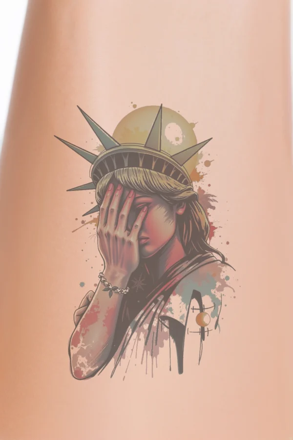 A vibrant temporary temporary tattoo design featuring a stylized portrait of the Statue of Liberty, illustrated in bold red, yellow, and blue hues with accents of white and black. The statue's iconic crown is prominently displayed, and its serious expression is partially obscured