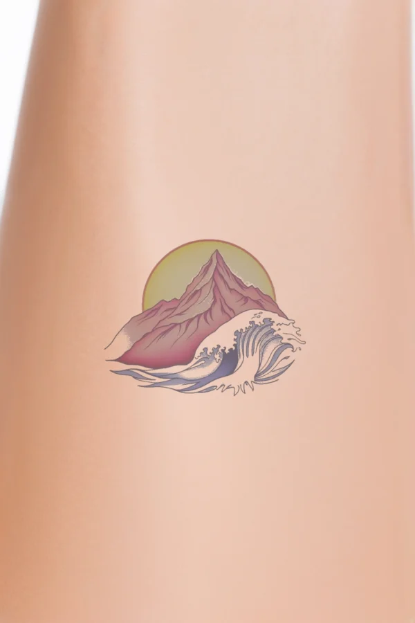 Colorful temporary temporary tattoo featuring a vibrant mountain range with a prominent central peak, rendered in shades of pink and red with a gradient effect. Behind the mountains, a bright yellow sun is partially hidden by a large, stylized wave in blue and white,