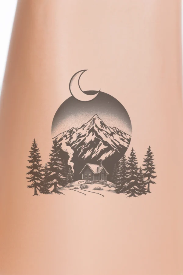 Black and white temporary temporary tattoo design featuring a tranquil winter landscape. At the center, a quaint cabin with a dark roof and chimney is nestled in a snowy setting, surrounded by evergreen trees. A dramatic mountain range in shades of gray and black frames the scene